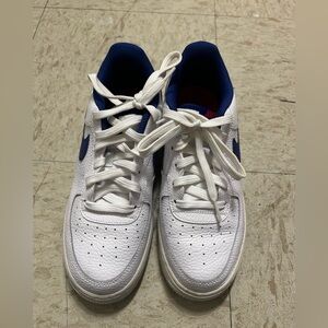 White, blue and red Nike shoes